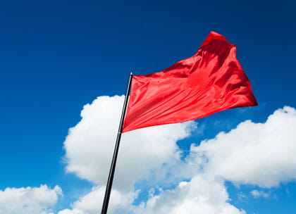 Red flag against blue sky